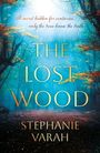 Text: "A secret hidden for centuries... only the trees know the truth. THE LOST WOOD. STEPHANIE VARAH." Mystischer Wald in Blautönen.