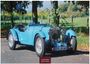 Text: „British Classic Cars 2027, Casares Edition.“  
Ein blauer Oldtimer steht auf einer Straße im Herbst.