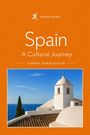 „Spain, A Cultural Journey: Traditions, Food & Local Life.“ Ein weißer Glockenturm mit Meerblick und blauem Himmel.