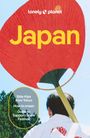 „Japan“, „Side trips from Tokyo“, „How to onsen“, „Guide to Sapporo Snow Festival“, jemand mit rotem Fächer von hinten.
