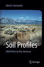 Text: Alfred E. Hartemink, Soil Profiles, With Photos by Roy Simonson. Sicht auf eine trockene Landschaft mit Bergen. Springer-Logo.