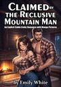 „Claimed by the Reclusive Mountain Man“ von Emily White. Ein Mann und eine Frau in einer Hütte mit Kamin im Hintergrund.