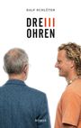Zwei Männer, einer älter, einer jünger, schauen sich an. Oben die Worte: "Ralf Schlüter DREI OHREN". Unten: "ROMAN".