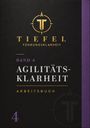 Band 4: Agilitätsklarheit Arbeitsbuch. Logo mit T und Kompass, dunkel mit lila und goldenen Akzenten.