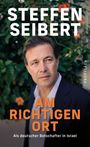 "STEFFEN SEIBERT. AM RICHTIGEN ORT. Als deutscher Botschafter in Israel." Ein Mann vor blühendem Hintergrund.