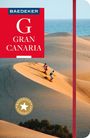 "BAEDEKER GRAN CANARIA" in Weiß auf rotem Hintergrund. Zwei Personen laufen eine Sanddüne hinab mit Meer im Hintergrund.