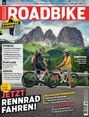Oben: "ROADBIKE". 
Unten: "JETZT RENNRAD FAHREN!" 
Vorn: Zwei Radfahrer vor Bergkulisse.