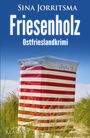 „Friesenholz, Ostfrieslandkrimi.“ Ein rot-weiß gestreifter Strandkorb steht in einer Dünenlandschaft.