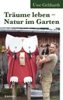 "Träume leben – Natur im Garten". Uwe Gebhardt. Ein Mann hält einen Hund. Eine große Eule aus Materialien steht daneben.