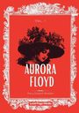 Vol. I, Aurora Floyd, Marry Elizabeth Braddon. Illustration einer Frau mit Hut und Blumen, umrahmt von dekorativer Verzierung.