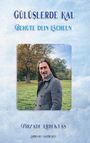"GÜLÜŞLERDE KAL - Behüte dein Lächeln" steht oben. Darunter ein Mann im Mantel vor einem Baum und Wiese. "PİRZADE ERBİLTAŞ".