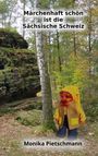 "Märchenhaft schön ist die Sächsische Schweiz. Monika Pietschnann." Eine Puppe in gelber Kleidung steht im Wald.