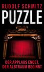 Text: "Rudolf Schmitz: PUZZLE. Der Applaus endet, der Albtraum beginnt." Roter Vorhang in einem opulenten Theater.