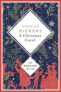 "Charles Dickens: A Christmas Carol. The English Edition. Illustration: Silhouetten und Pflanzenornamente auf dunklem Hintergrund."