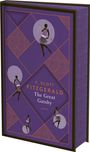 "F. Scott Fitzgerald, The Great Gatsby, ANACONDA" steht auf einem lila Buchcover mit Art Deco Mustern und Tänzerin-Silhouetten.
