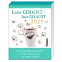 Leise GEDACHT - laut GELACHT 2027. Kaffeetasse mit lachendem Gesicht, umgeben von kleinen fröhlichen Smileys.