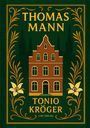 "THOMAS MANN. TONIO KRÖGER. LIWI VERLAG." Illustration eines roten Backsteinhauses, umrahmt von goldenen Blumen und Ranken.