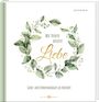 Text: "Wir feiern unsere Liebe" in einem floralen Kranz. "Gäste- und Erinnerungsbuch zur Hochzeit."
