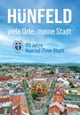 Text: "HÜNFELD viele Orte, meine Stadt. 20 Jahre Konrad-Zuse-Stadt." 
Panorama einer Stadt mit vielen roten Dächern.