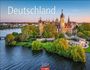 "Deutschland, Germany, 2027, WEINGARTEN" – Ein Schloss umgeben von Wasser und Bäumen im Sonnenuntergang.