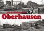 Text: „Verkehrsknoten Oberhausen“ in roten Buchstaben. Szenen mit alten Zügen und Industrieanlagen.