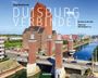 Texte: Duisburg verbindet. Jörg Mascherrek. Brücken in die Welt. Fotos von Udo Kloppert u.a. Wienand. 

Bild: Brücke mit Gebäuden am Wasser.