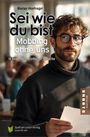 "Sei wie du bist: Mobbing ohne uns." Ein Mann mit Brille und Bart hält ein Blatt Papier.