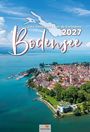 „Lake Constance | Lac de Constance 2027 Bodensee“. Luftaufnahme einer Stadt am Bodensee mit klarem Himmel.