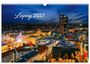 Text: "Leipzig 2027". 

Nachtansicht der Stadt Leipzig mit beleuchtetem Riesenrad und modernen Gebäuden.