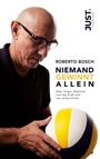 "JUST VERLAG" Logo, "ROBERTO BOSCH: NIEMAND GEWINNT ALLEIN", ein Glatzköpfiger mit Brille hält einen gelben und blauen Ball.