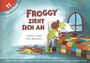 „Froggy zieht sich an“ in verschiedenen Sprachen oben links. Ein Frosch zieht sich vor einem Bett an.
