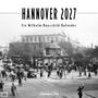 "HANNOVER 2027, Ein Wilhelm Hauschild Kalender" in großen Lettern. Historische Straßenszene mit Menschen und Autos.