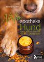 „Naturapotheke Hund“ von Martina Flocken, Bild: Hundepfote neben Kräutersalbe mit Blüten.