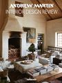 „ANDREW MARTIN INTERIOR DESIGN REVIEW“. Ein gemütlicher Raum mit Kamin, Büchern, einem Sessel und Pflanzen.