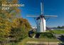 Titel: "Niederrhein 2027". Eine weiße Windmühle mit roter Tür neben herbstlichen Bäumen unter blauem Himmel.