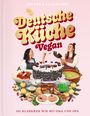Titel: "Deutsche Küche Vegan". Zwei Frauen lachen, umgeben von veganen Gerichten wie Torte, Brezeln und Suppe.