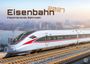 „Eisenbahn 2027: Faszinierende Bahnwelt.“ Ein moderner Hochgeschwindigkeitszug auf Gleisen, Stadt im Hintergrund.