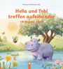 „Hella und Tobi treffen aufeinander. Ob das gut geht?“ Ein fröhliches Nilpferd steht im Wasser neben einem Baum.