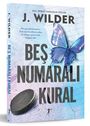 Auf dem Cover steht "J. Wilder - Beş Num aralı Kural" mit einem blauen Schmetterling und einem Hockeypuck.