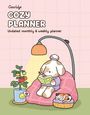"CocoWyo Cozy Planner, Undated monthly & weekly planner" in verspielten Buchstaben. Ein Hund liest im Sessel, daneben eine topfgepflanze.