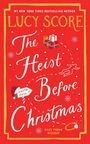 Oben: "Lucy Score" in großer gelber Schrift. Darunter: "The Heist Before Christmas." Illustrationen von Geschenken und Schneeflocken.