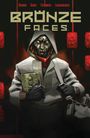 Oben steht: "BRONZE FACES". Eine Person mit metallischer Maske trägt Kapuze und Jacke, hält ein Buch.