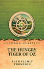 Text oben: "Lushena Classics." Titel: "The Hungry Tiger of Oz." Autor: "Ruth Plumly Thompson." Illustration: Kompass über Landschaft.